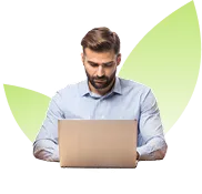 Man with beard and mustache focused on using a laptop.