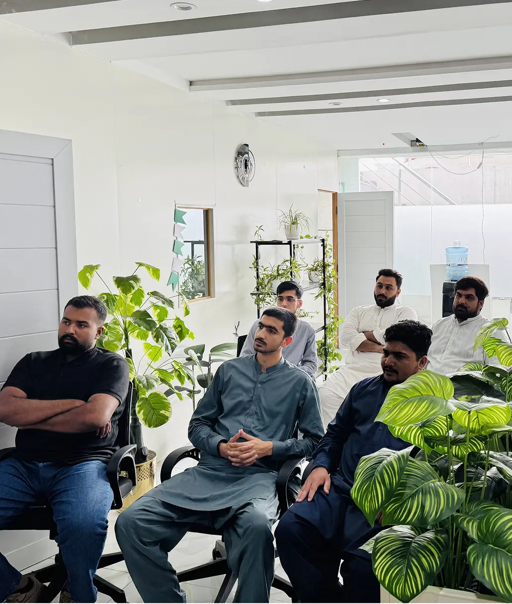 Developios team seated together in the plant-filled office