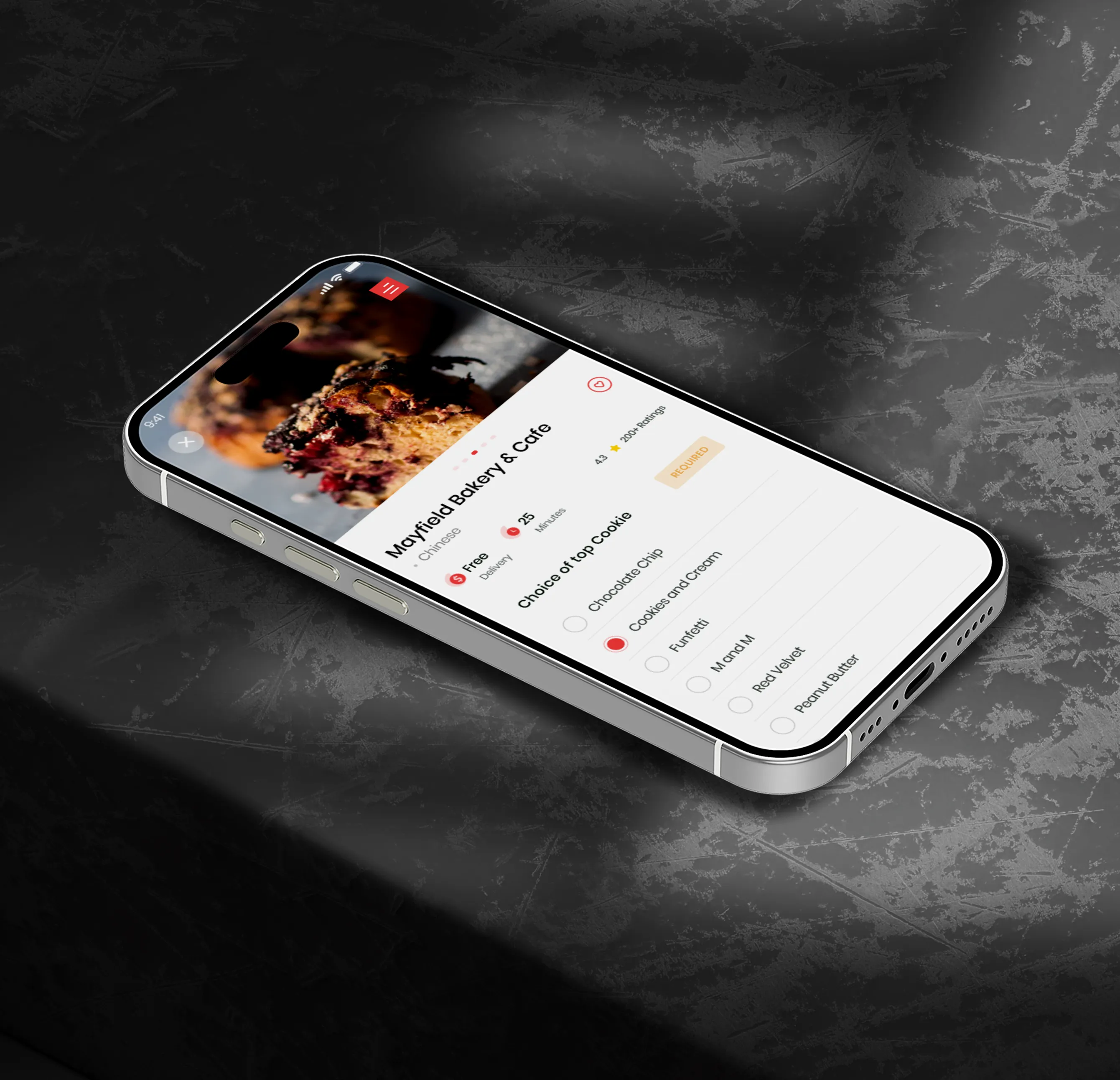 Smartphone displaying a bakery app with a photo of cookies and options to choose cookie flavors including chocolate chip and cookies and cream.