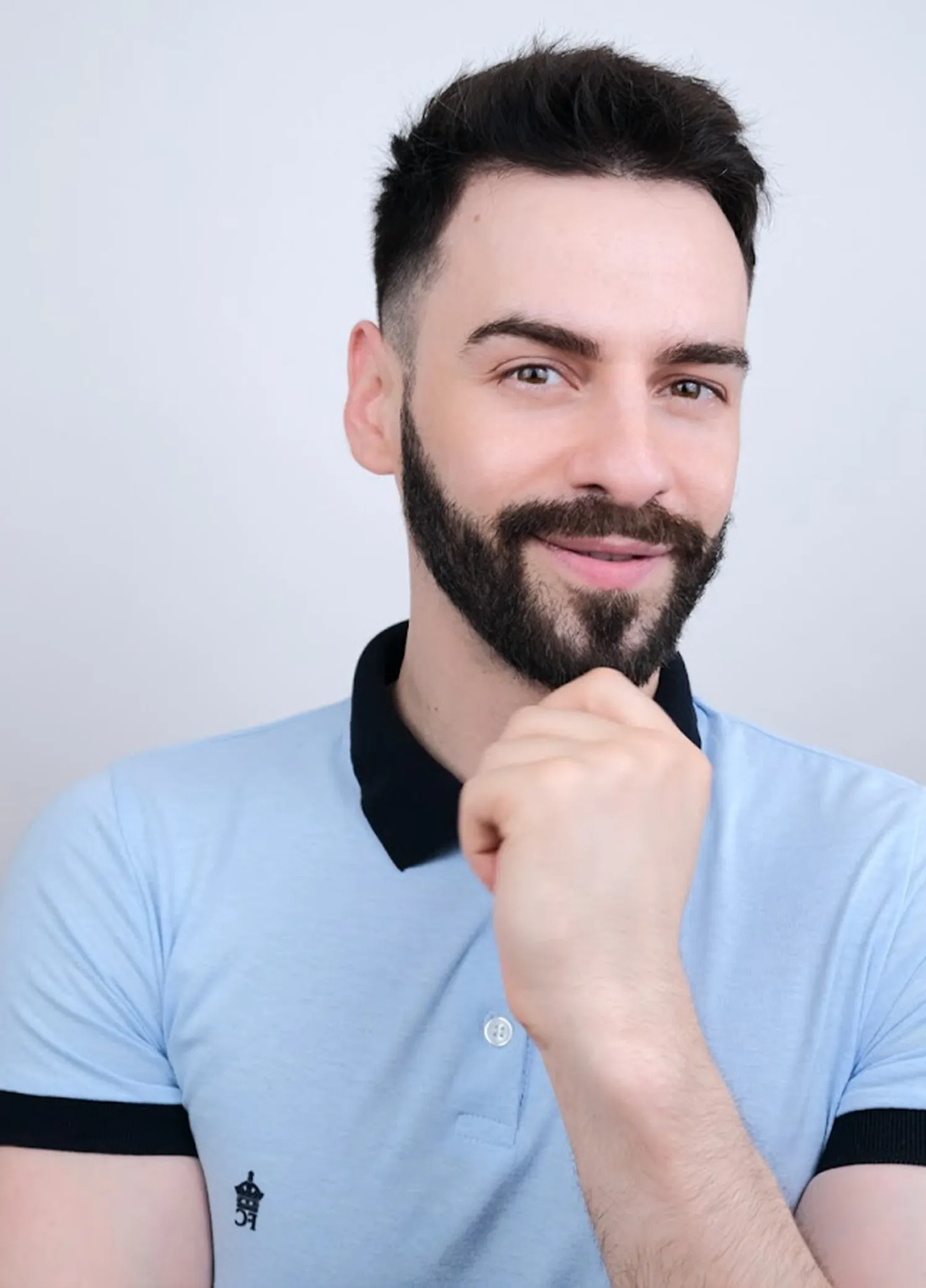 Sugar Baby skincare model using a facial cleansing brush