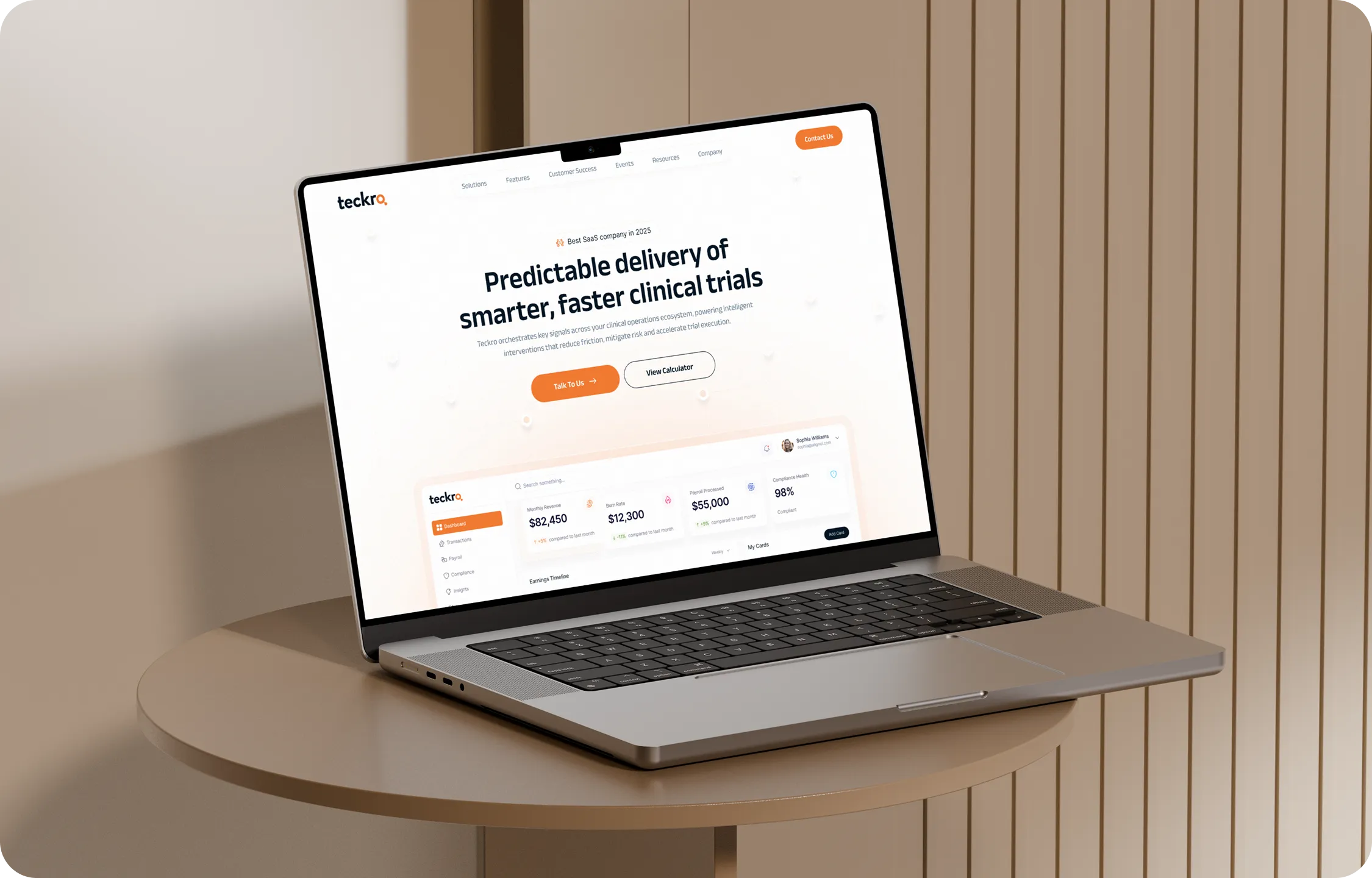 Laptop on round table displaying Teckro's website for smarter, faster clinical trials.