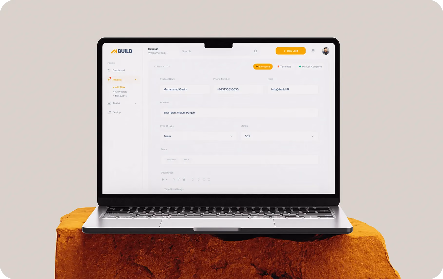 Open laptop displaying a project management interface with client details and status at 30%.