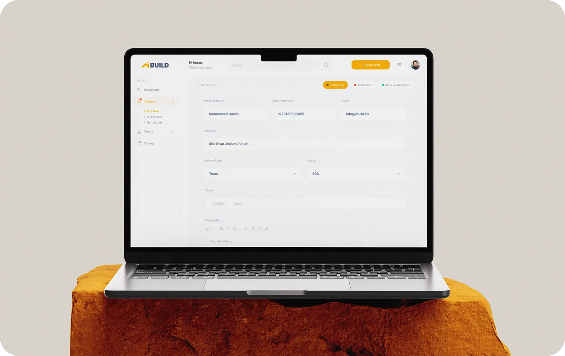 Open laptop displaying a project management interface with client details and status at 30%.