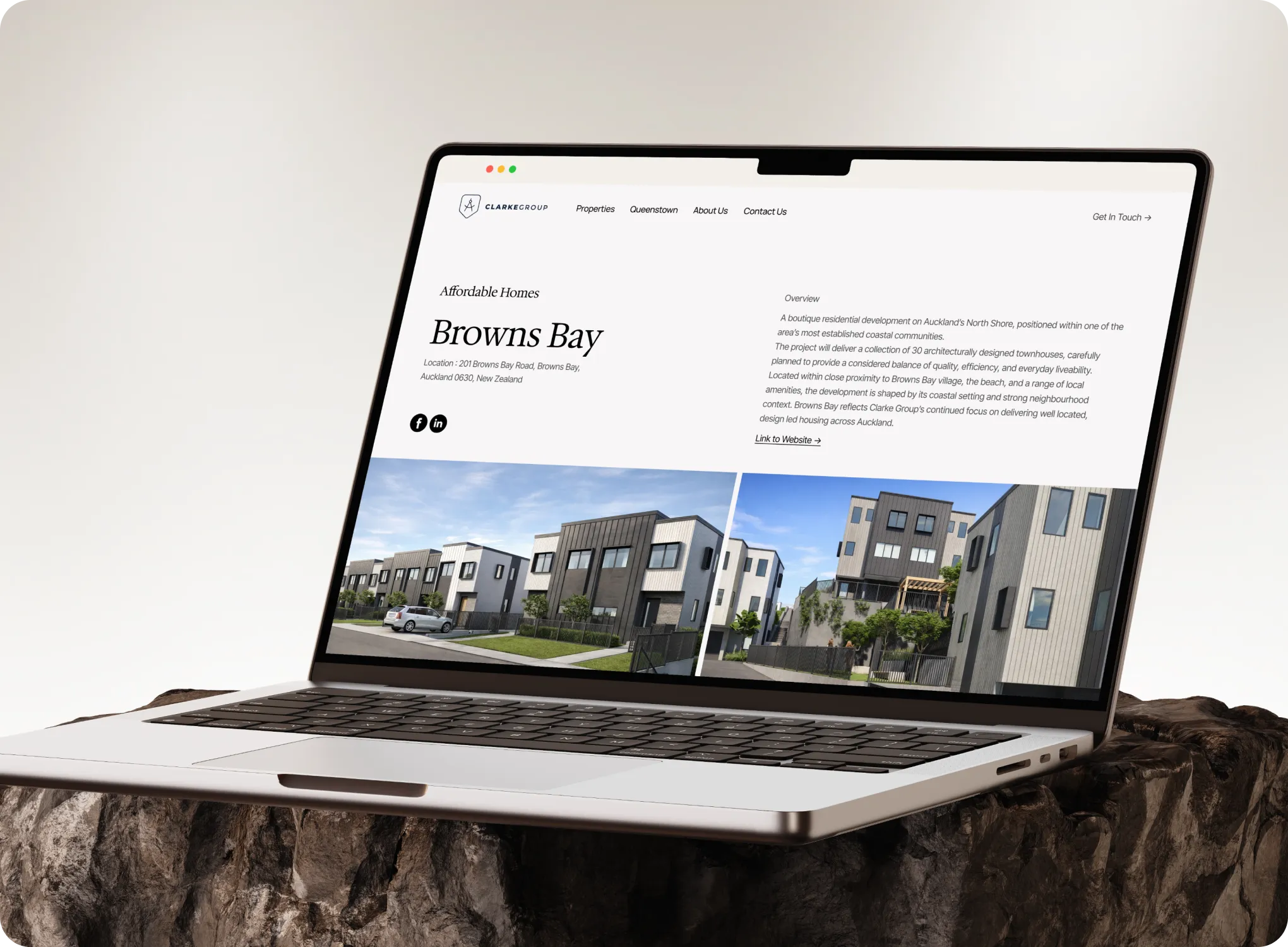 Laptop displaying Clarke Group website featuring Browns Bay affordable homes with property images.