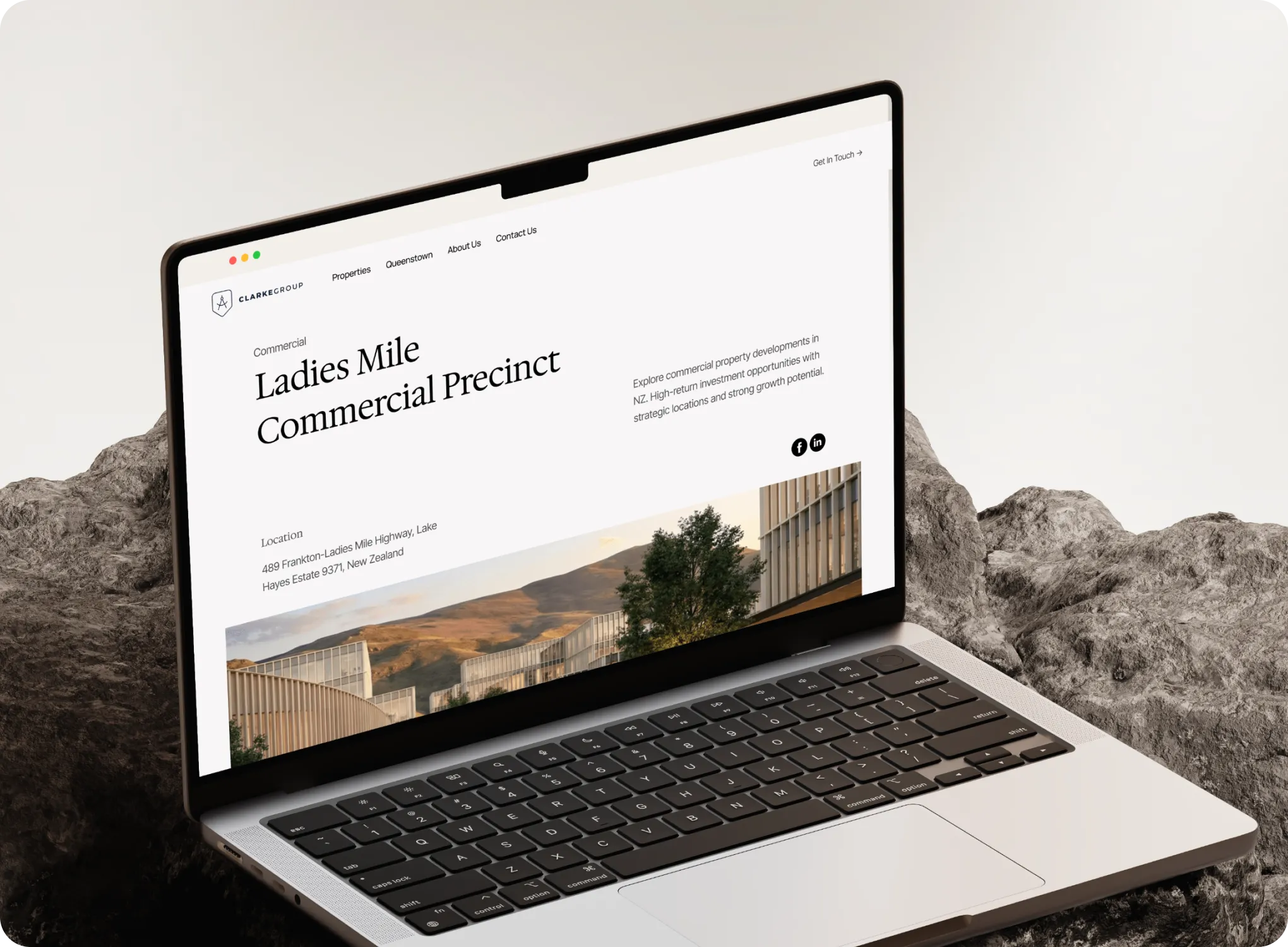 Laptop displaying a webpage about Ladies Mile Commercial Precinct in New Zealand by Clarke Group.