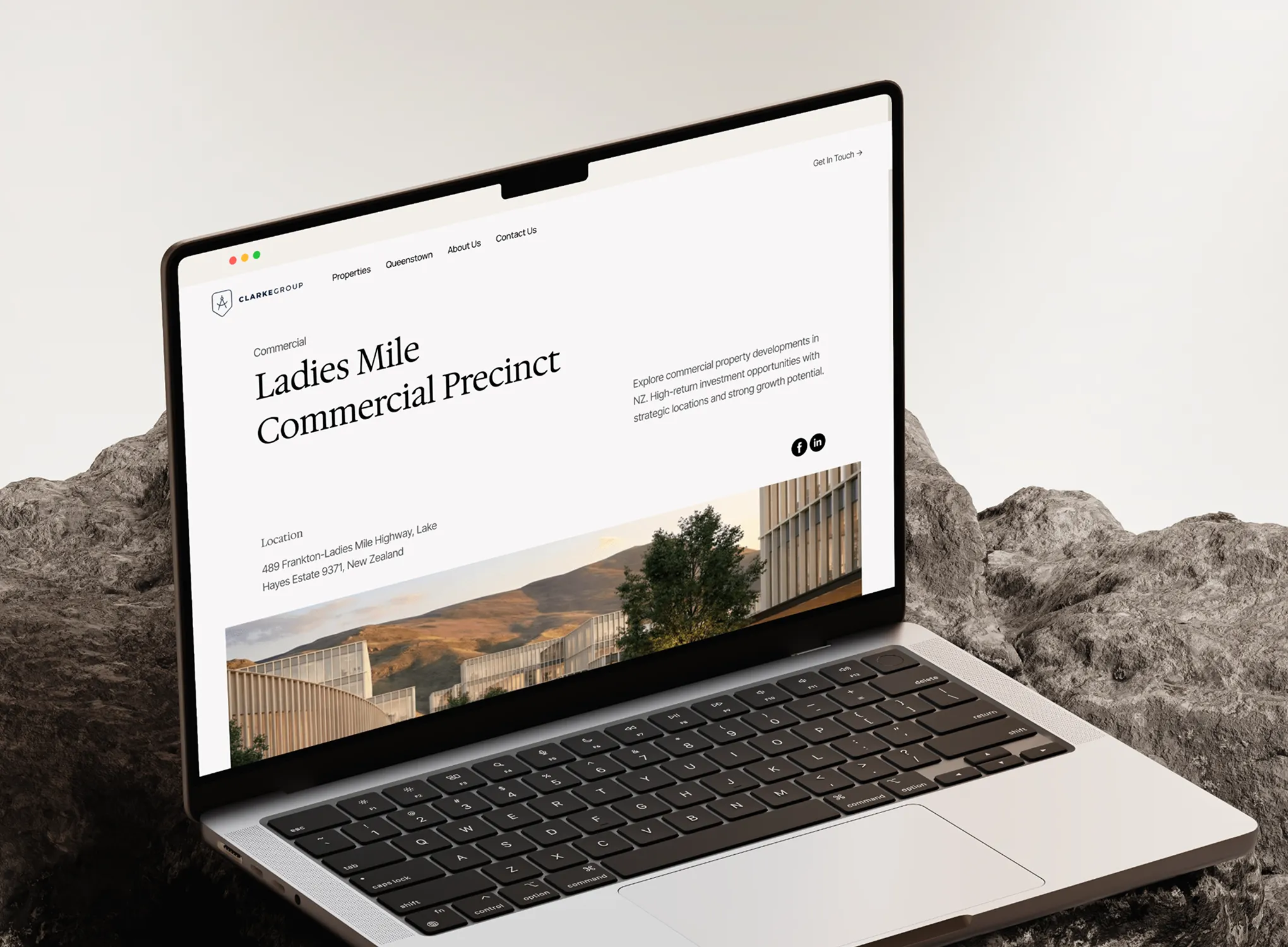 Laptop displaying a webpage about Ladies Mile Commercial Precinct in New Zealand by Clarke Group.