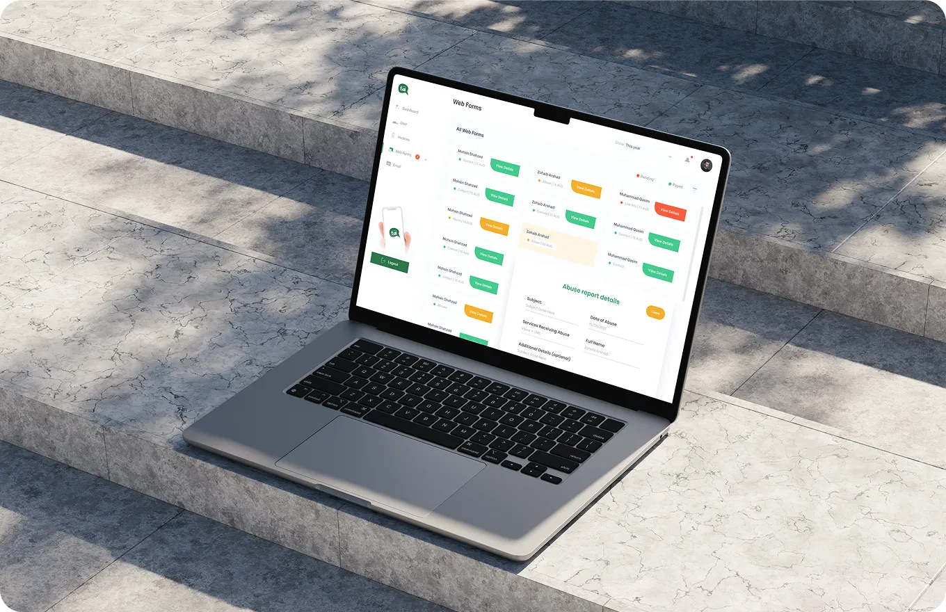 Laptop on stone steps showing a web forms dashboard with user details and abuse report information.