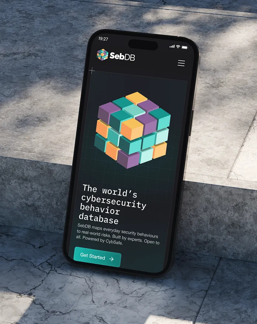 Smartphone screen showing SebDB site with a colorful 3D cube and cybersecurity behavior database text.