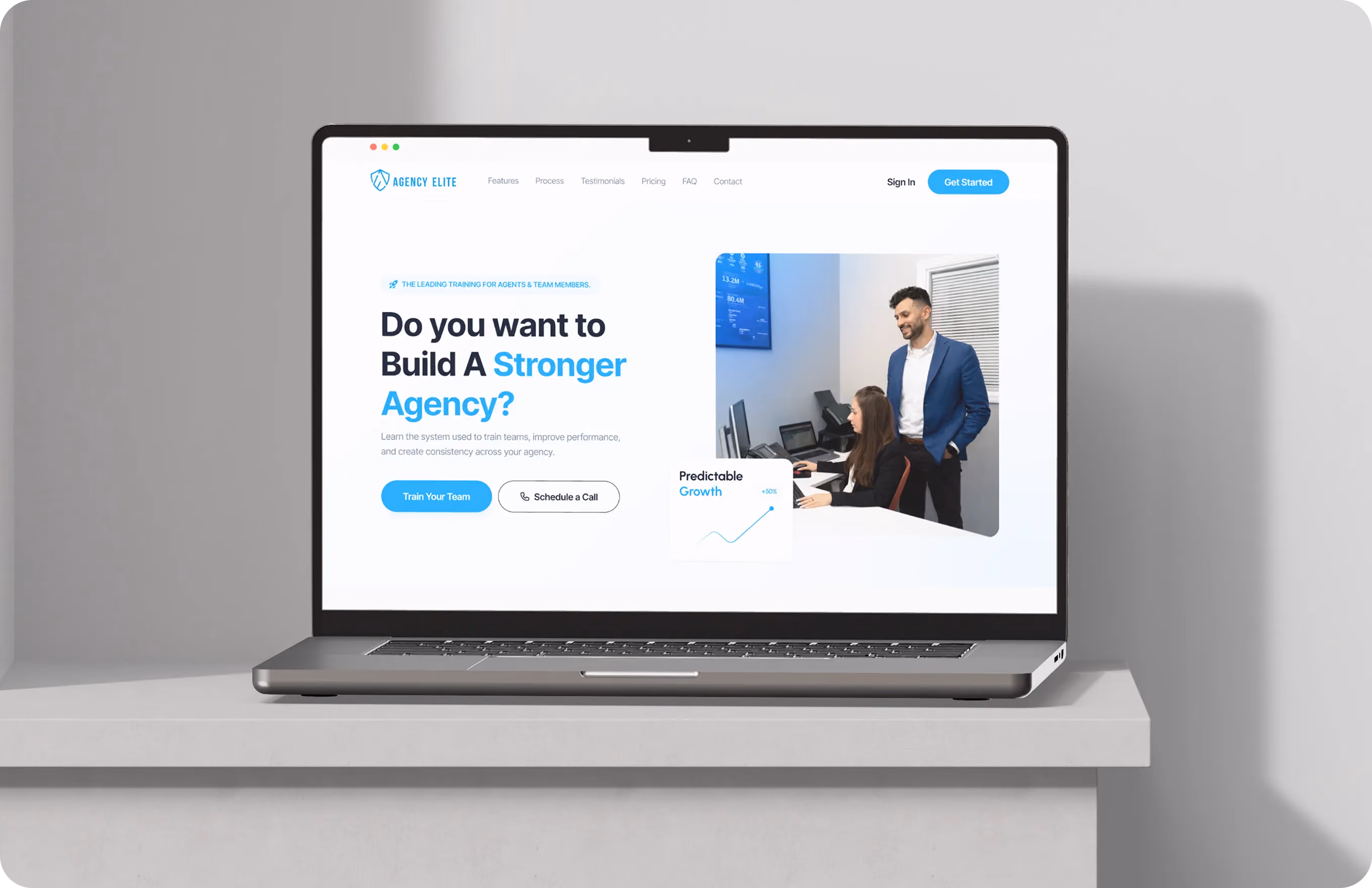 Laptop on desk showing Agency Elite site offering team training to build a stronger agency with call options.