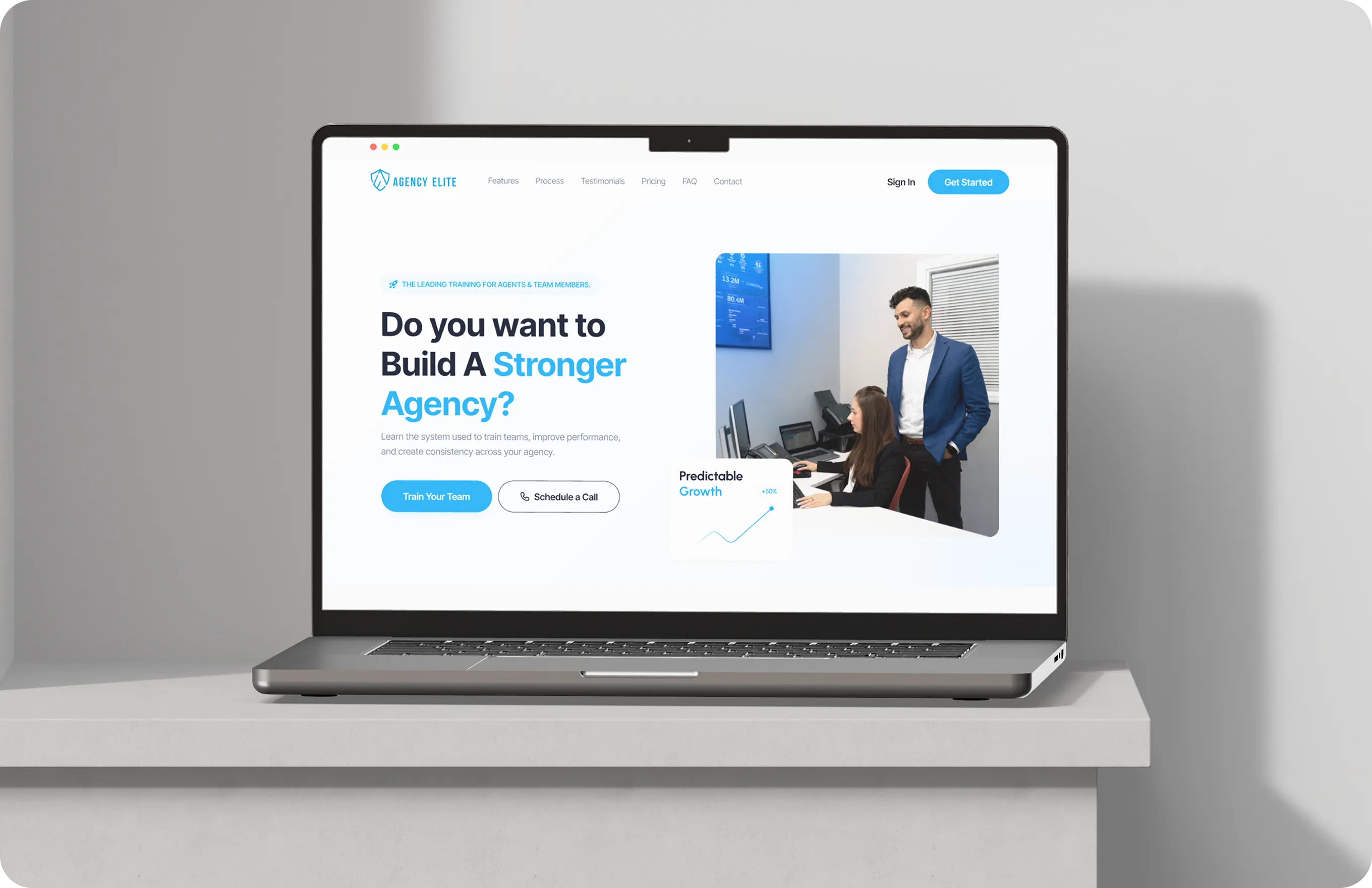 Laptop on desk showing Agency Elite site offering team training to build a stronger agency with call options.
