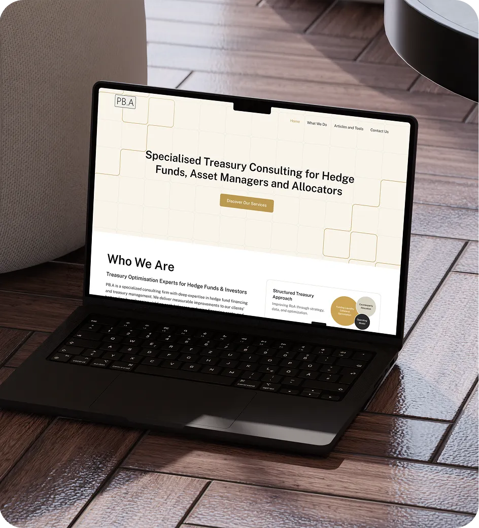 Laptop on wooden floor showing a consulting firm website for hedge funds and asset managers.