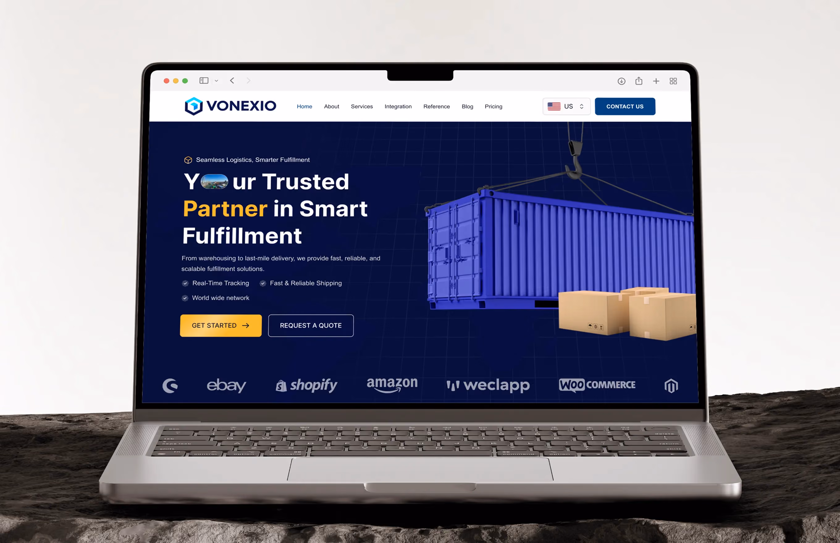 Laptop displaying Vonexio logistics website with blue shipping container and cardboard boxes.