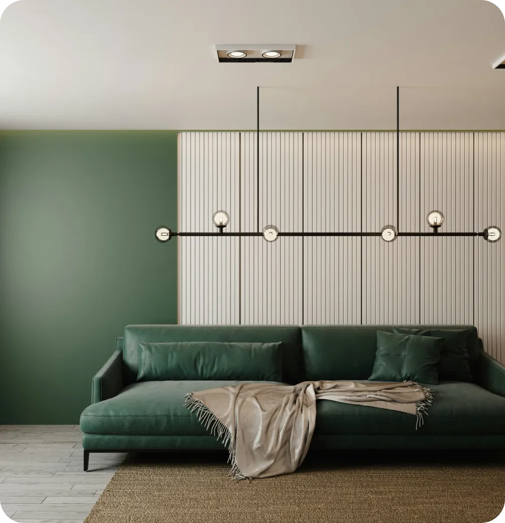 Modern green sofa with cushions and beige throw in front of white slatted wall and green paint.