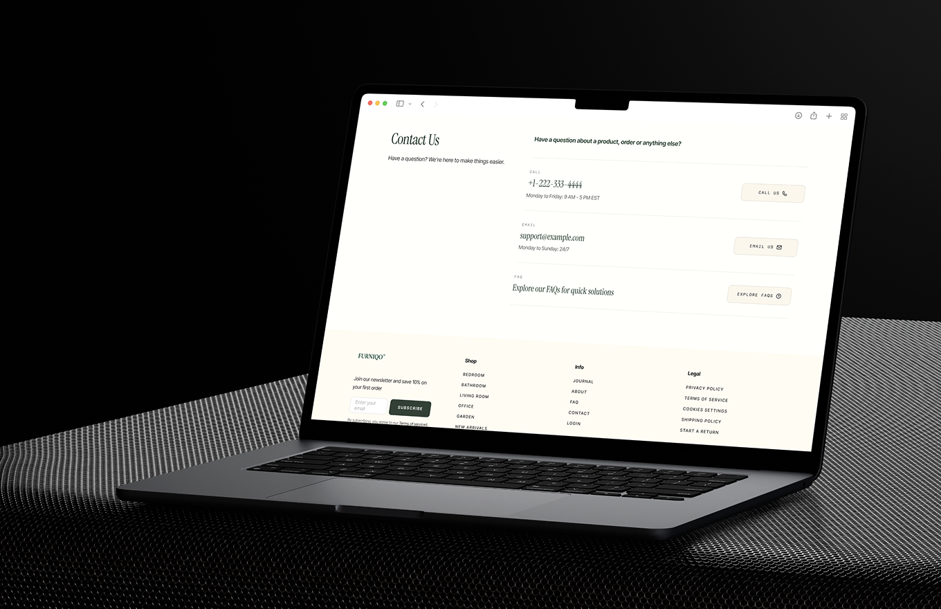 Open laptop displaying a contact us page with phone, email, and FAQ options on a dark textured surface.