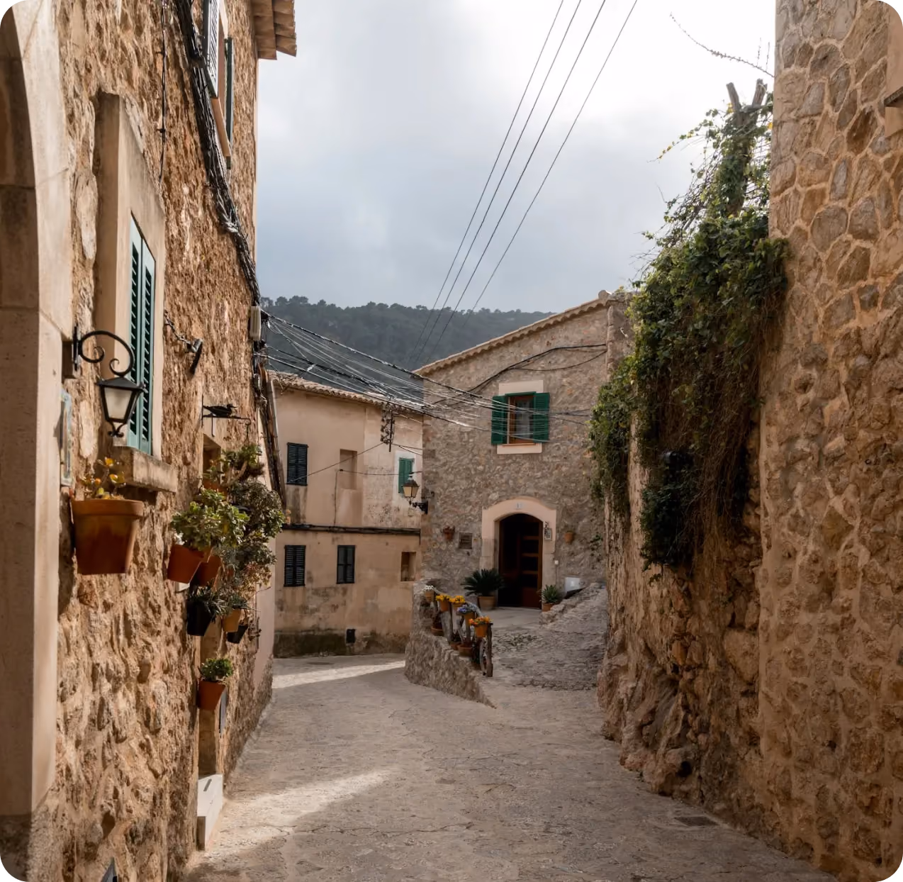 Stone-paved alley in a coastal Mediterranean village, one of Sailor's featured yacht charter destinations