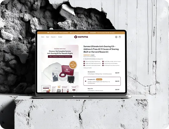 Laptop displaying Somma anti-snoring kit product page with images and pricing options on a textured concrete surface.