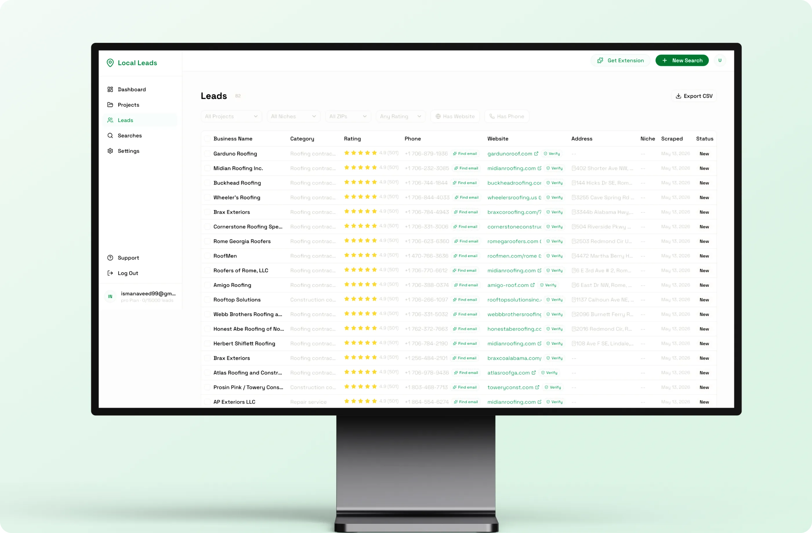 Desktop monitor showing the Local Leads leads table with business name, category, rating, phone, website and address columns