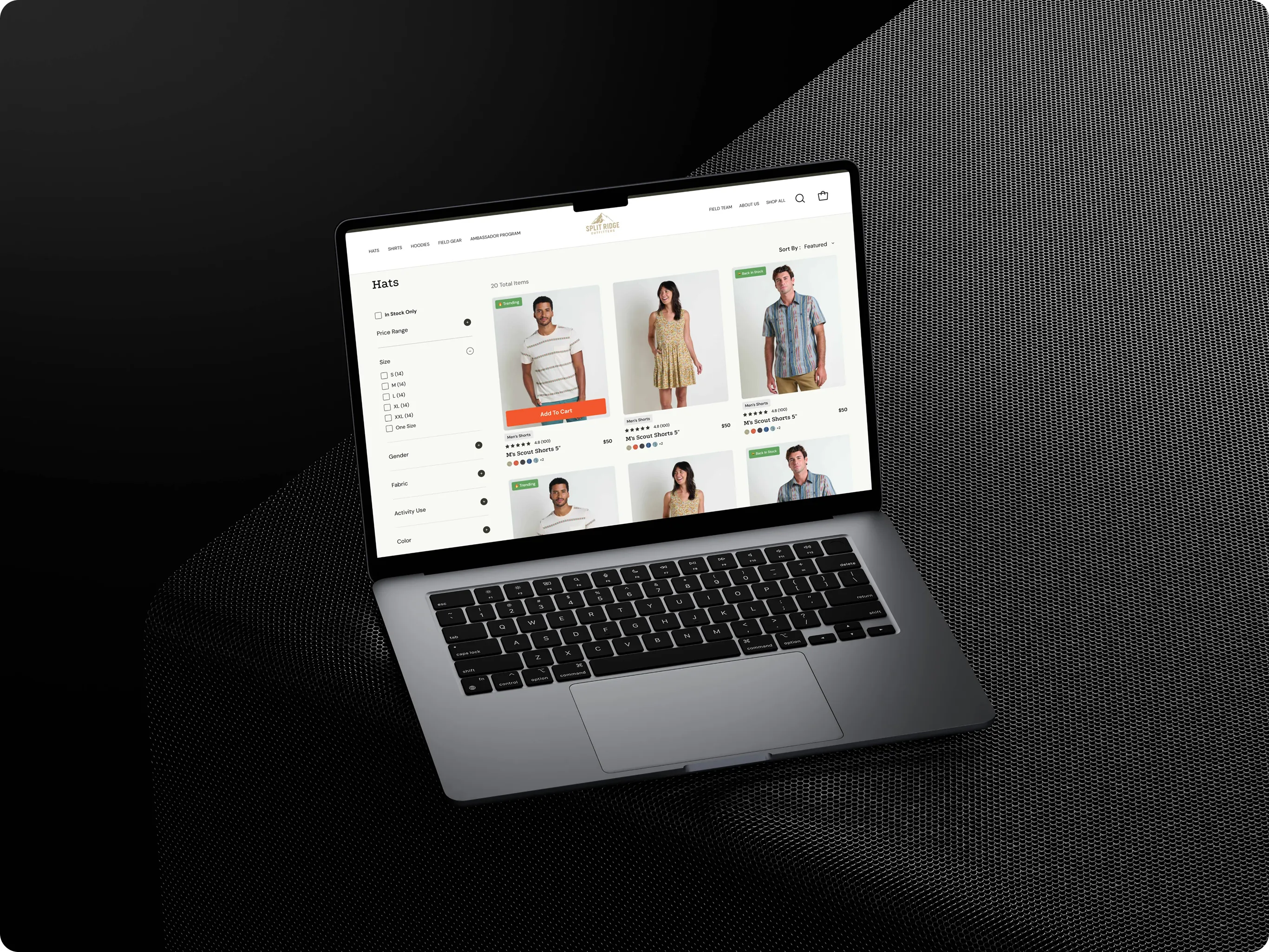Laptop showing the Split Ridge Outfitters product listing page with size, fabric and price filters beside a grid of apparel