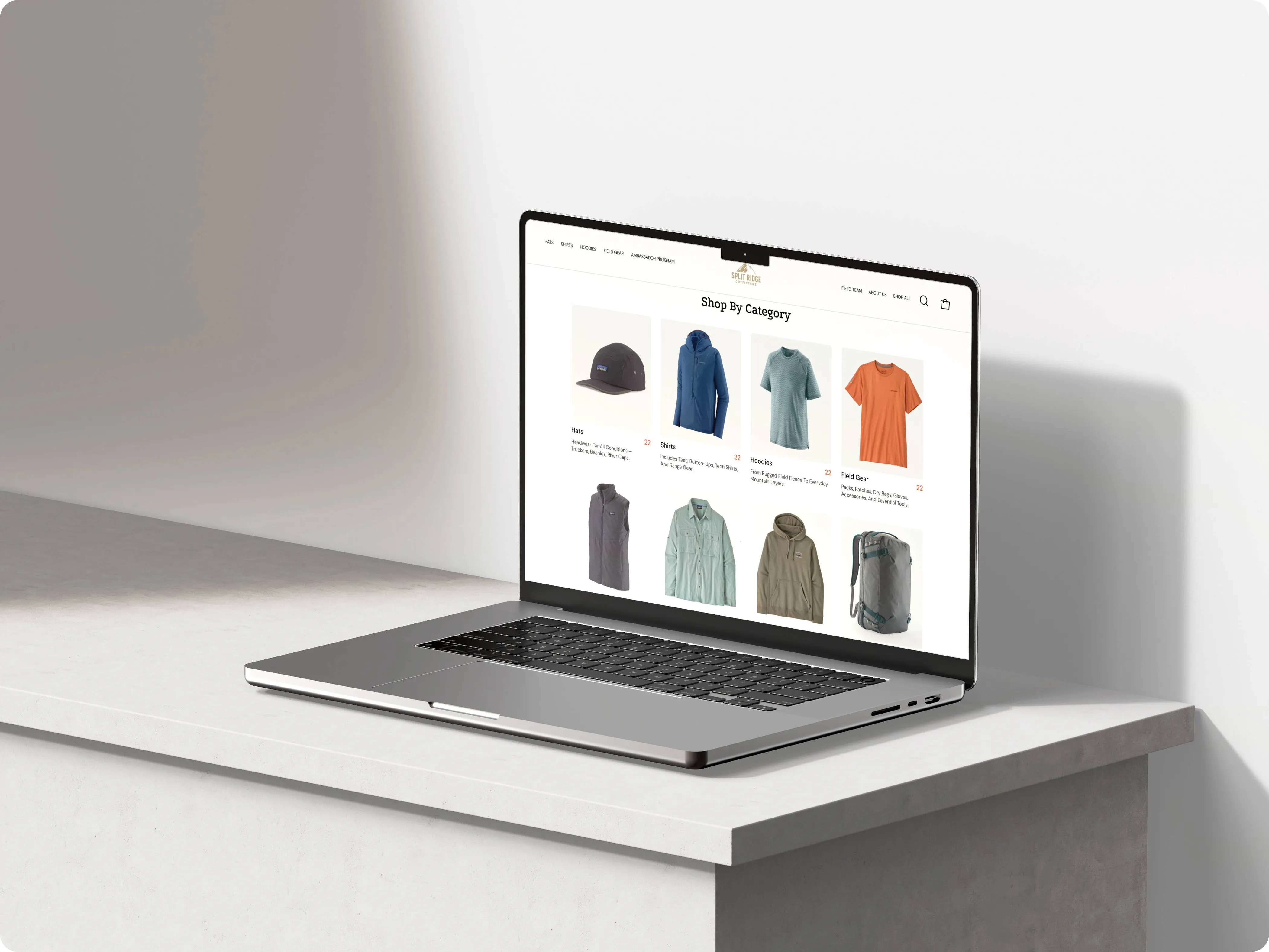 Laptop showing the Split Ridge Outfitters Shop By Category page with hats, jackets, shirts, vests, hoodies and field gear