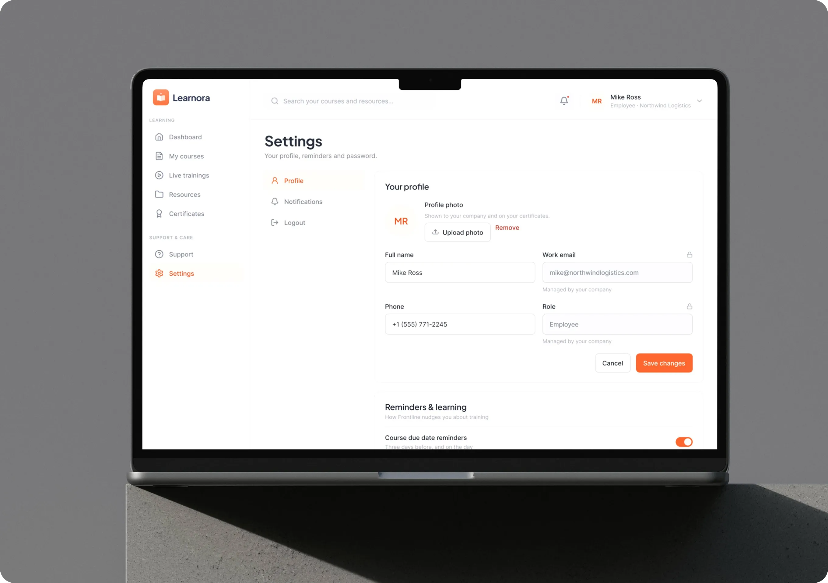 Learnora settings screen on a laptop showing a learner profile with photo, name and phone, work email and role locked as managed by the company, and course due date reminders.