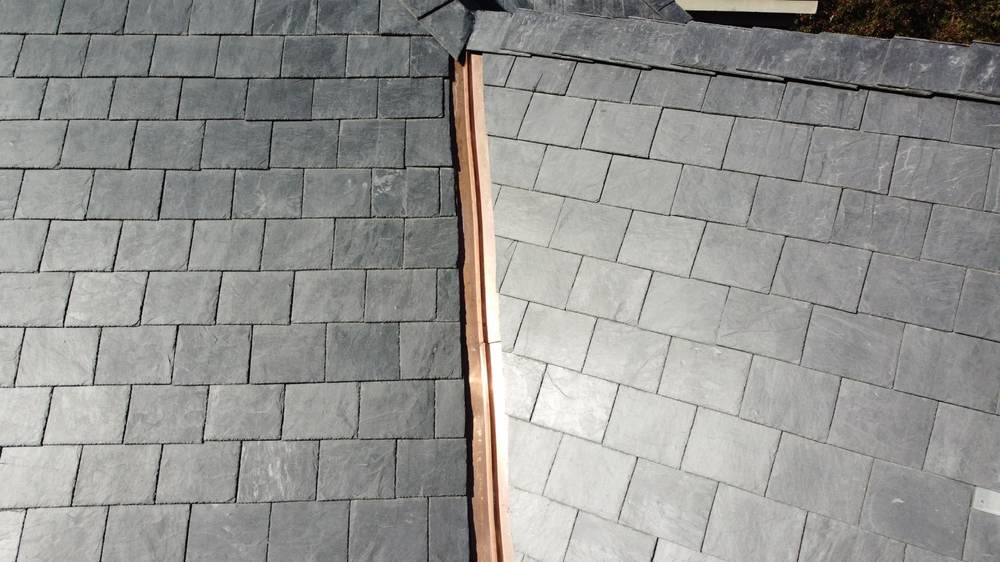 Close-up of composite slate tiles along a copper ridge