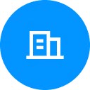 White building icon with windows inside a solid blue circle background.