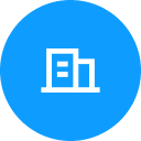 White building icon with windows inside a solid blue circle background.
