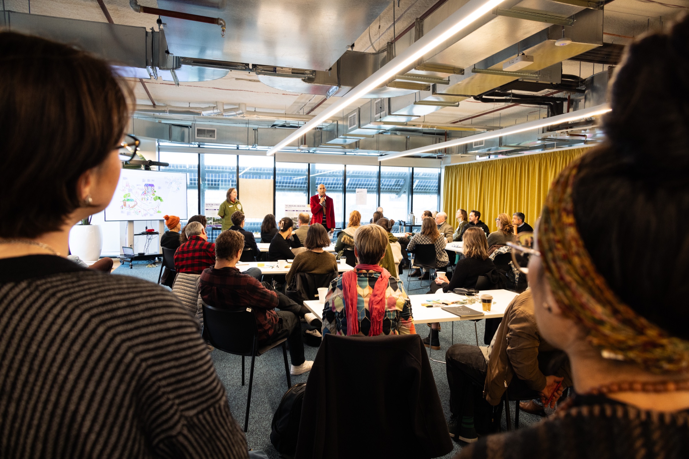 Presenter speaking to attendees at a Regen Melbourne City Portrait workshop