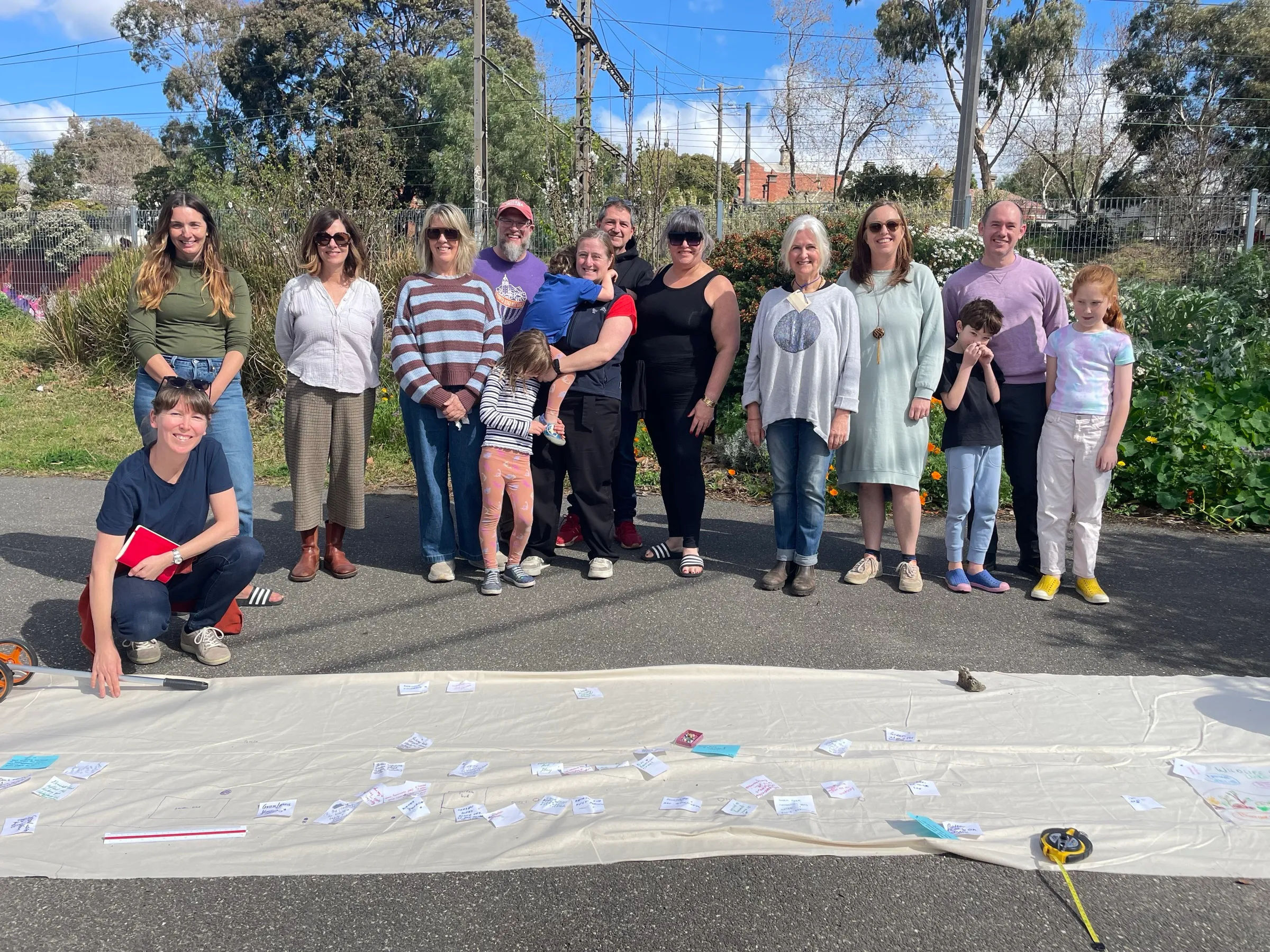 Regen Melbourne group making heart shapes with their hands at a community garden