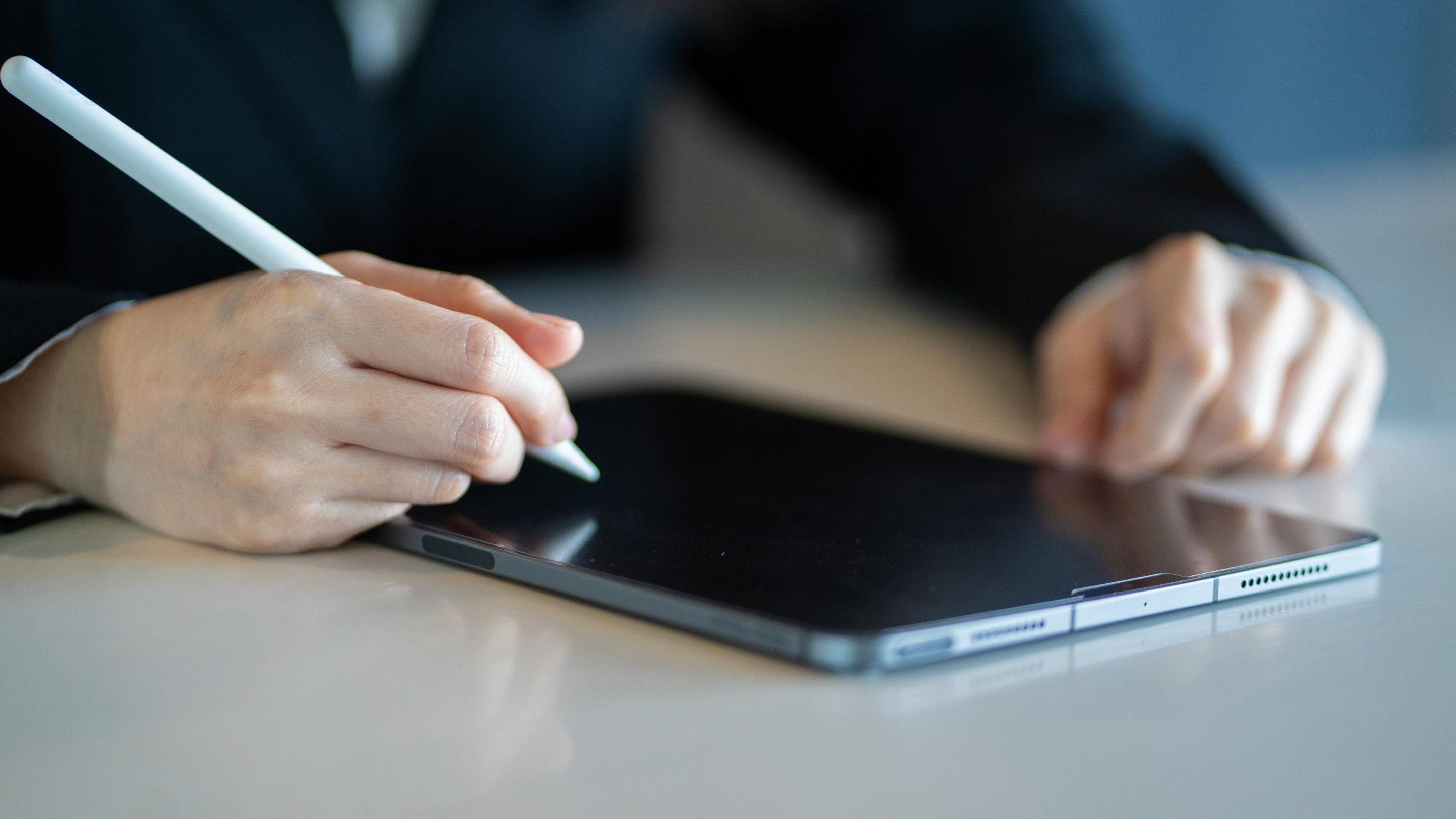 A contemporary house with a towering tree in the foreground.