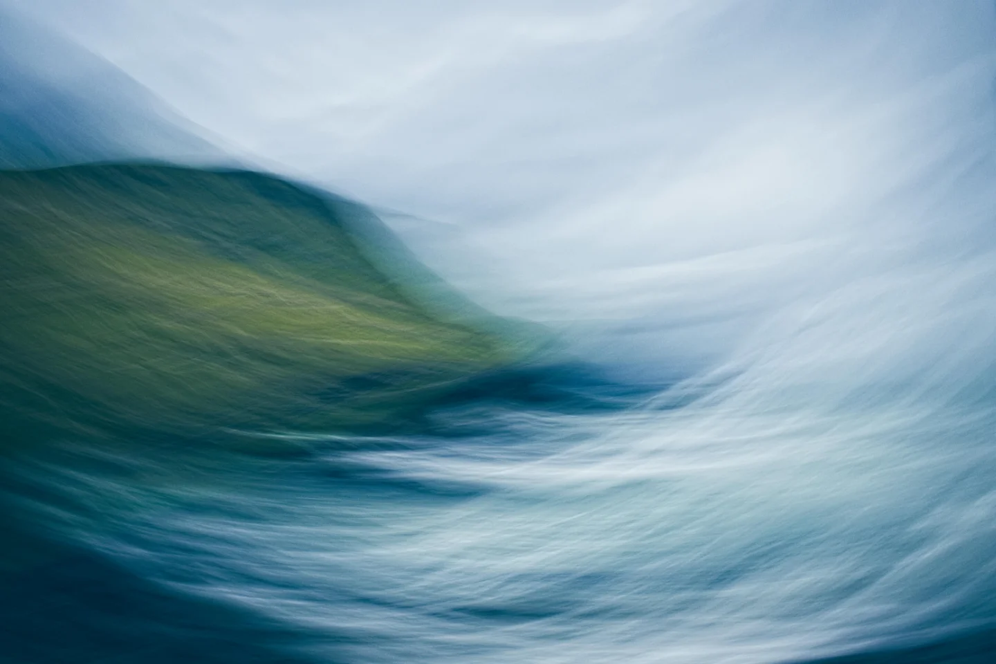 Abstract blurred image of a green hill with flowing blue and white streaks resembling water and sky.