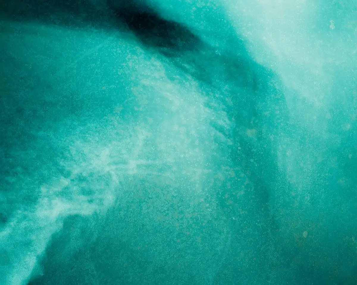 Abstract marble-like fluid art with swirls of white, beige, brown, and hints of gray.