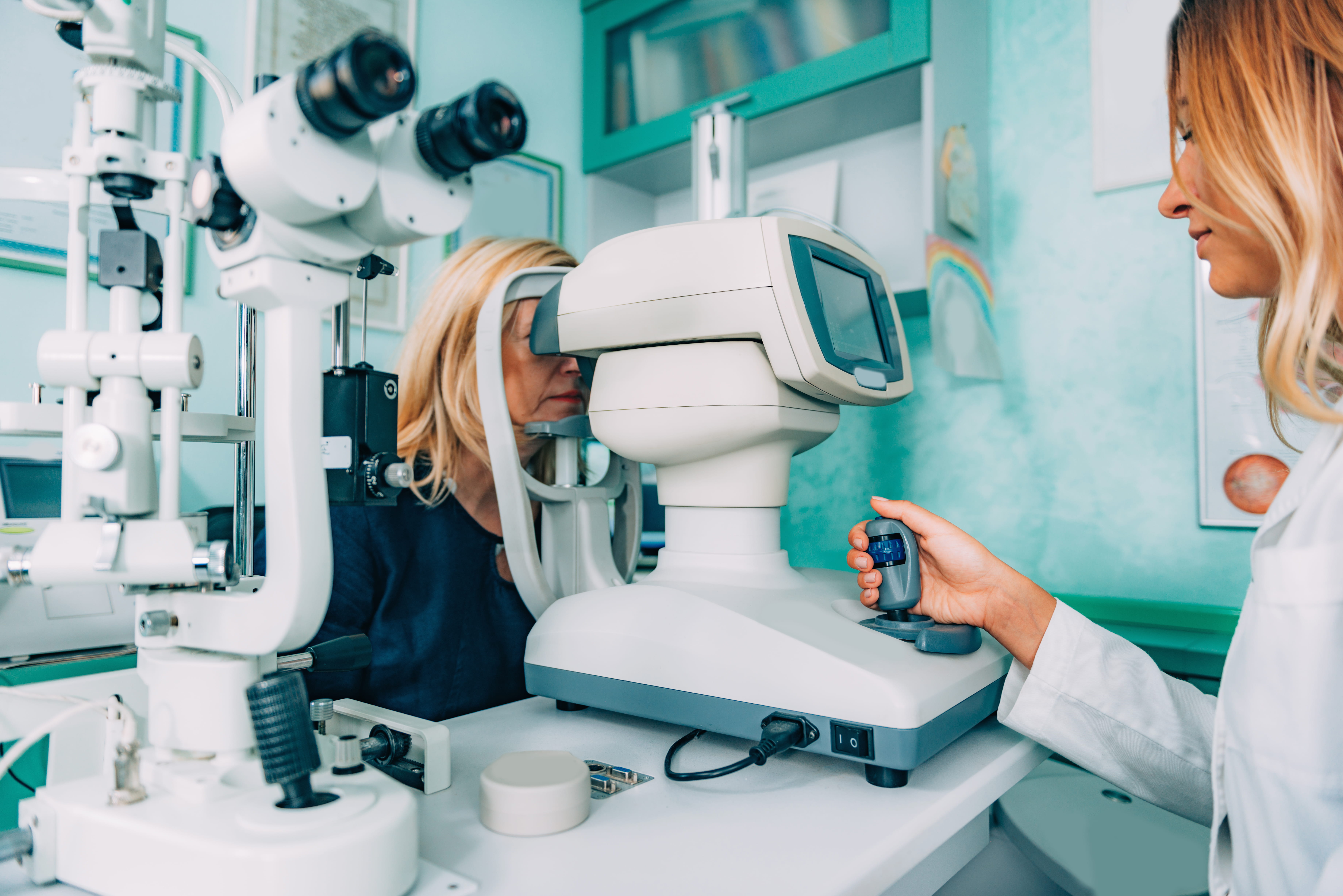 Woman undergoing eye exam with advanced optometry equipment in modern clinic.