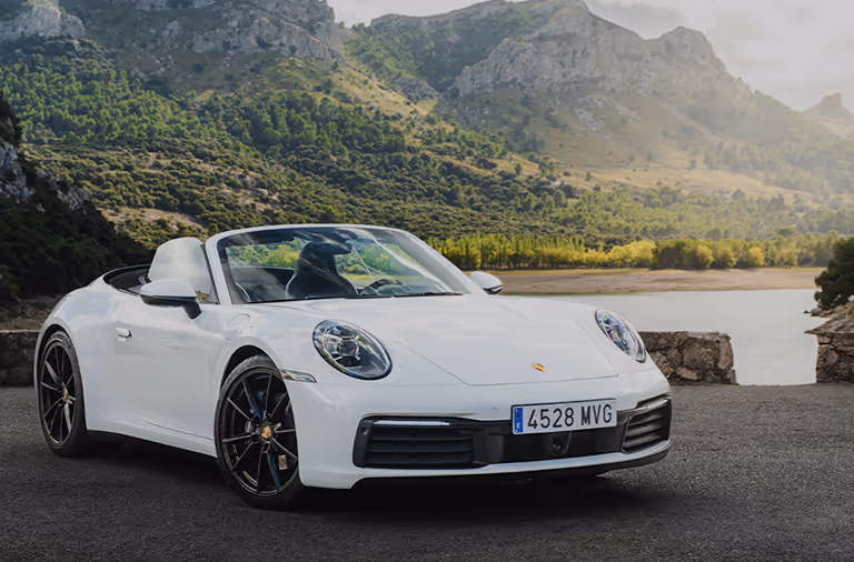 White Porsche convertible parked on a winding Mallorca mountain road