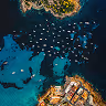 Aerial cove and boats — "Where to Stay" guide