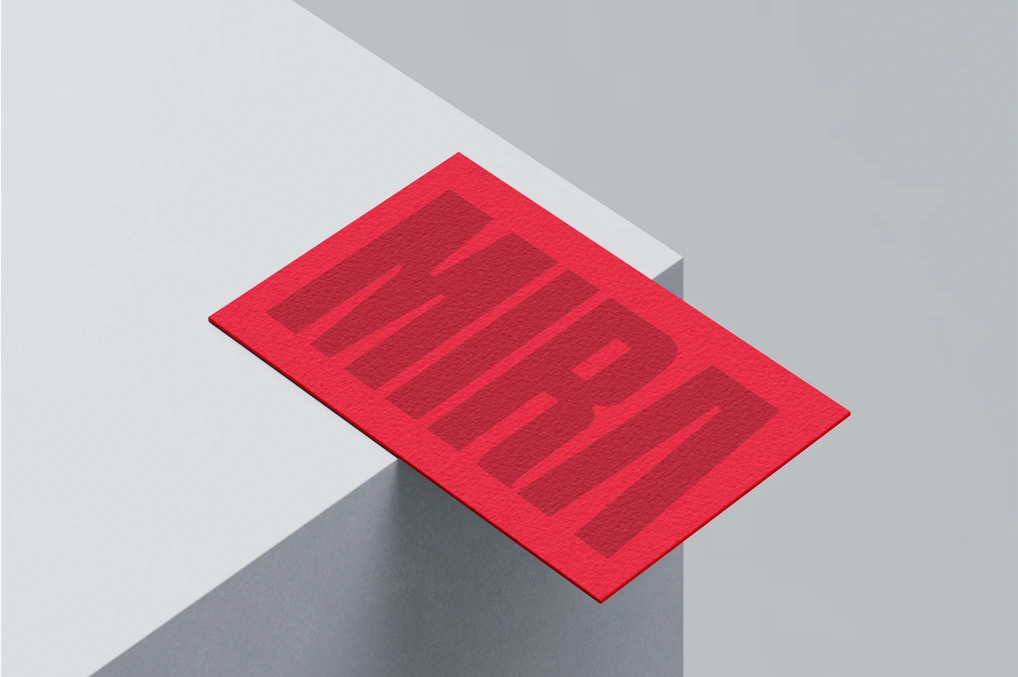 Red business card with the word 'MIRA' in large, bold, slightly darker red letters placed on the edge of a white surface.