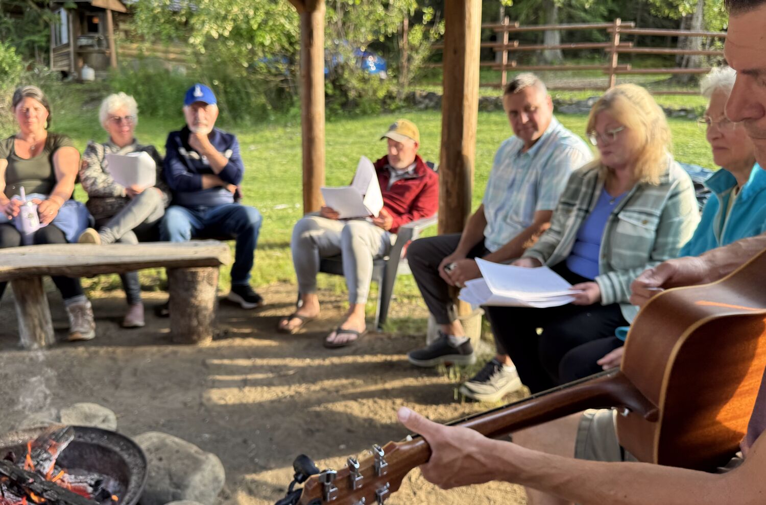 Healing guests singing around the fire pit at praise and prayer, The Healing Oasis