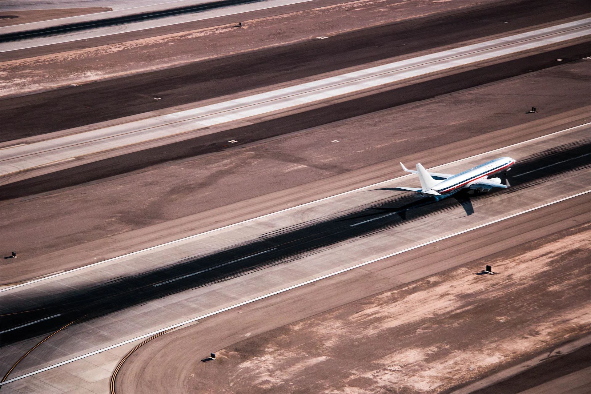 Aerial photo of a plane on a runway.