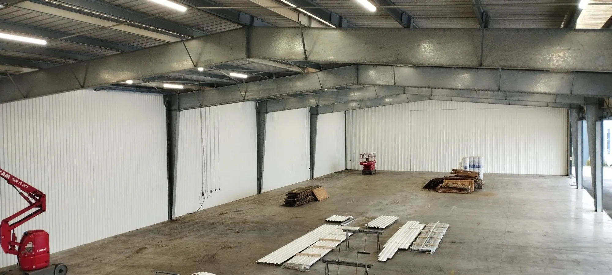 Corner of a blue architectural blueprint on a white surface casting a shadow.