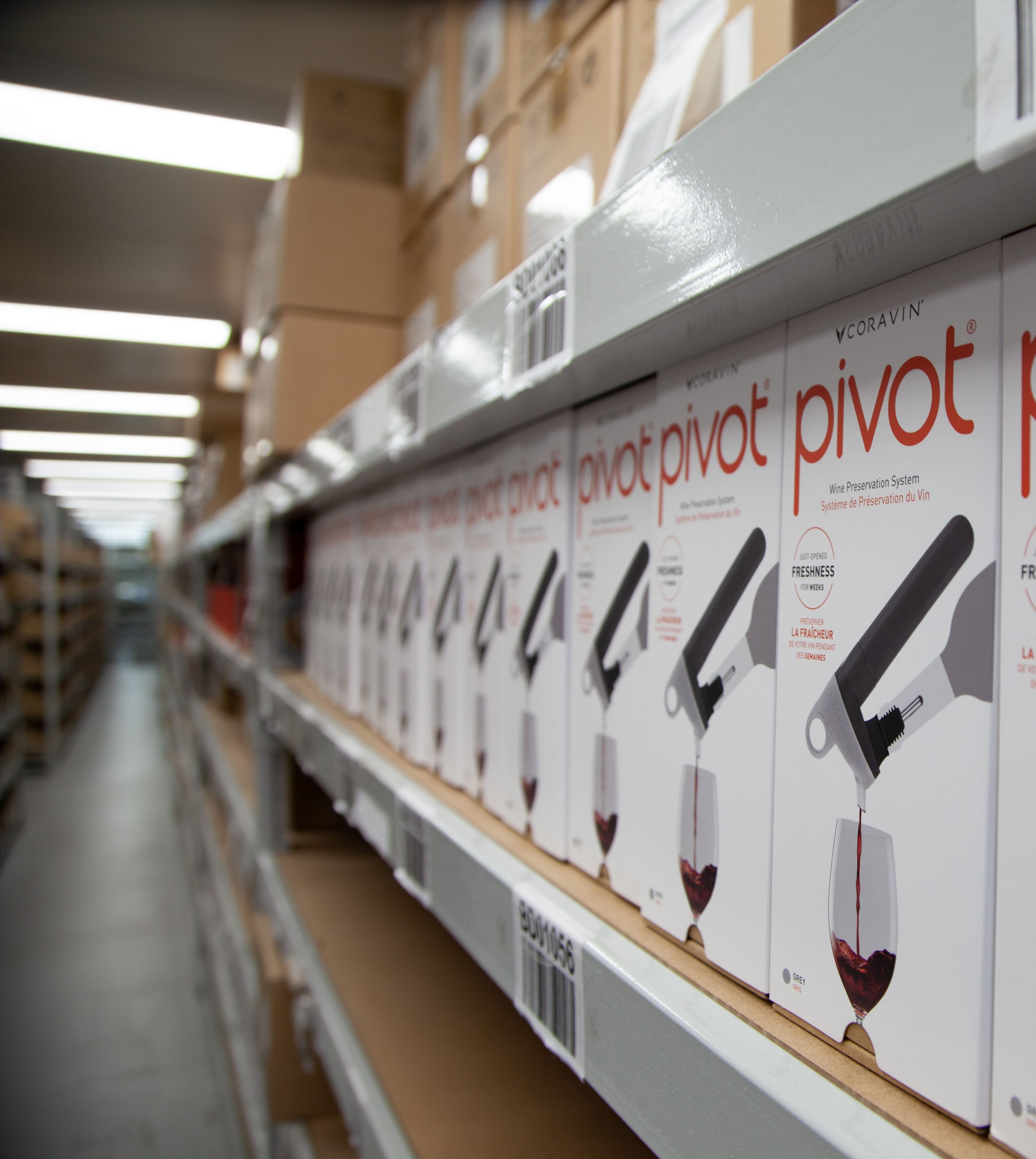 Row of boxes of Coravin Pivot wine preservation systems lined up on a store shelf.