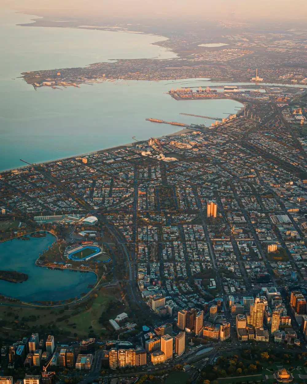 Aerial view of Melbourne across Albert Park and Port Phillip Bay