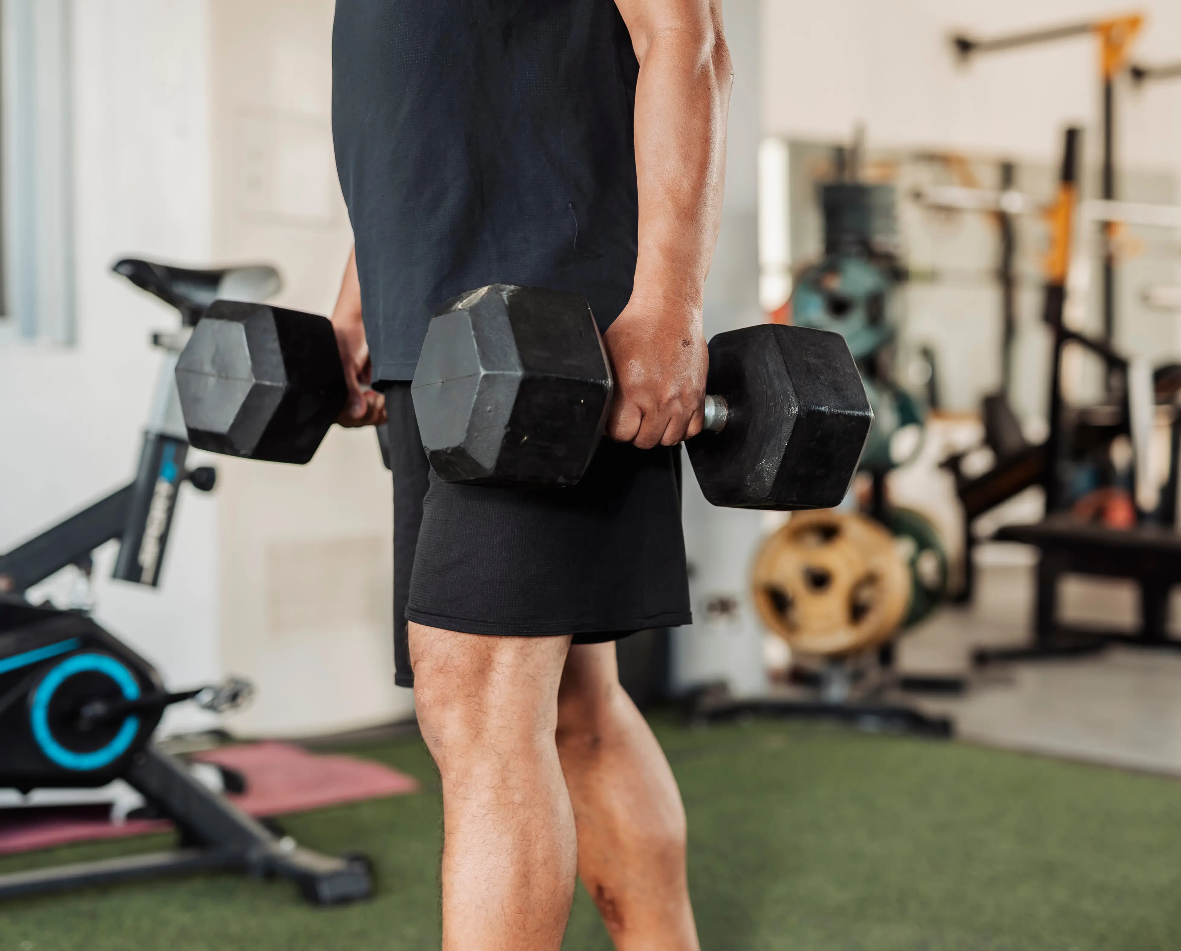 A man holding two dumbbells