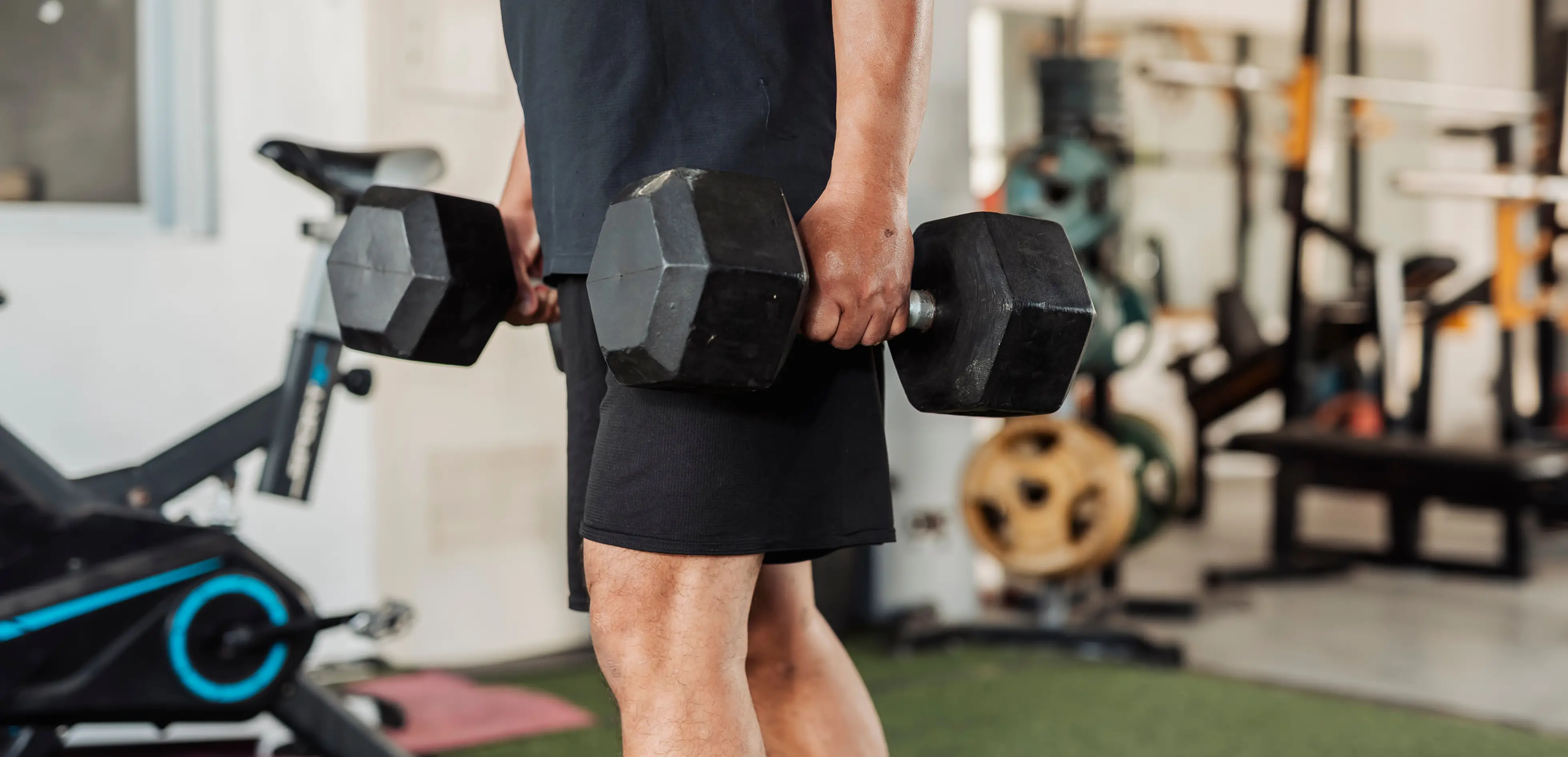 A man holding two dumbbells