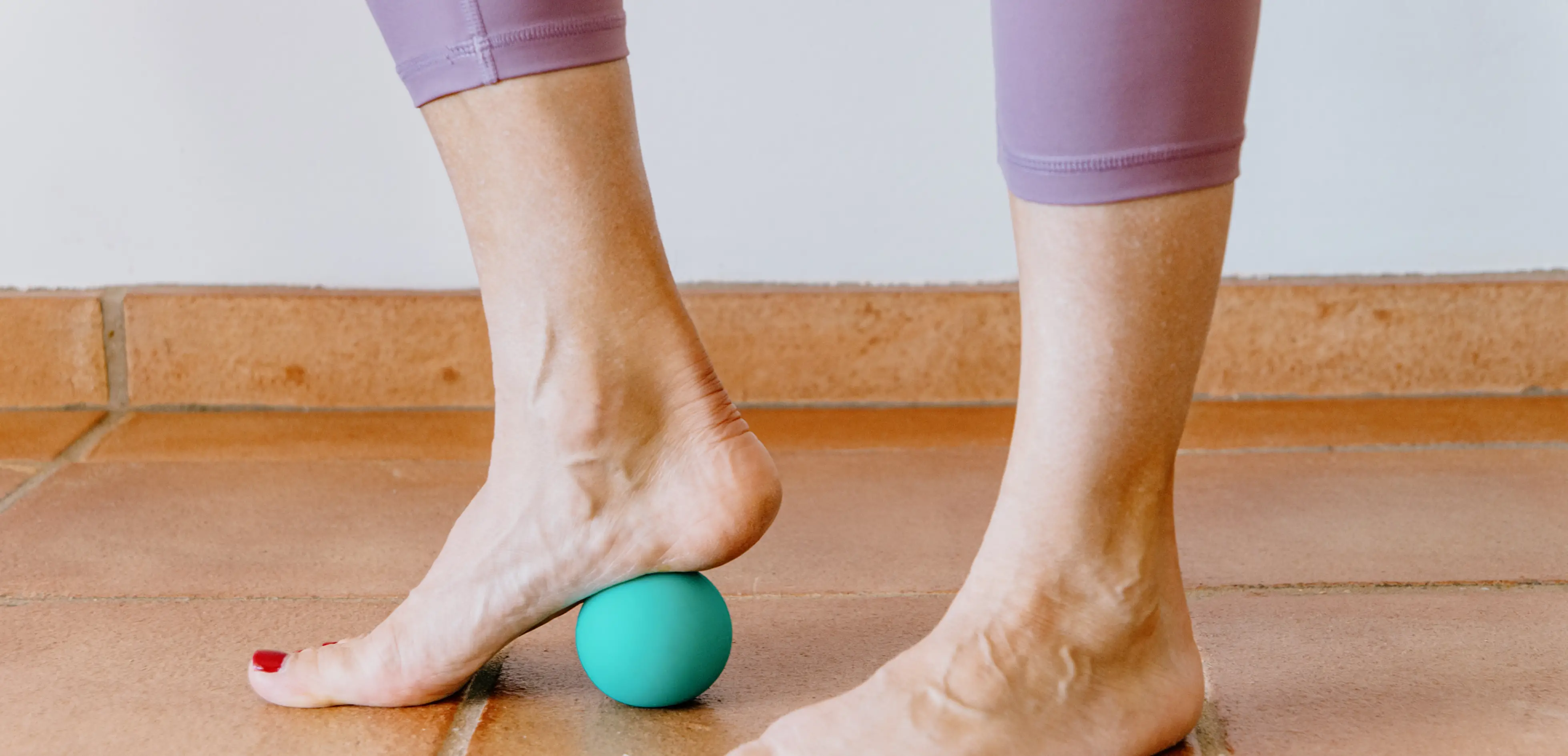 A foot rolling a ball