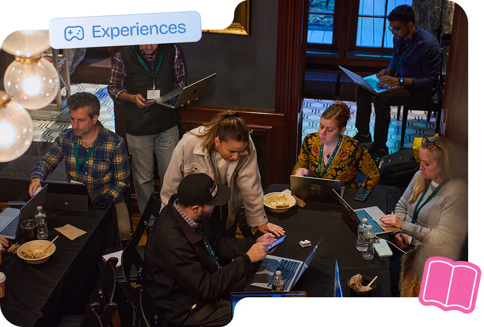 Participants collaborating on laptops during an immersive MLOps workshop experience