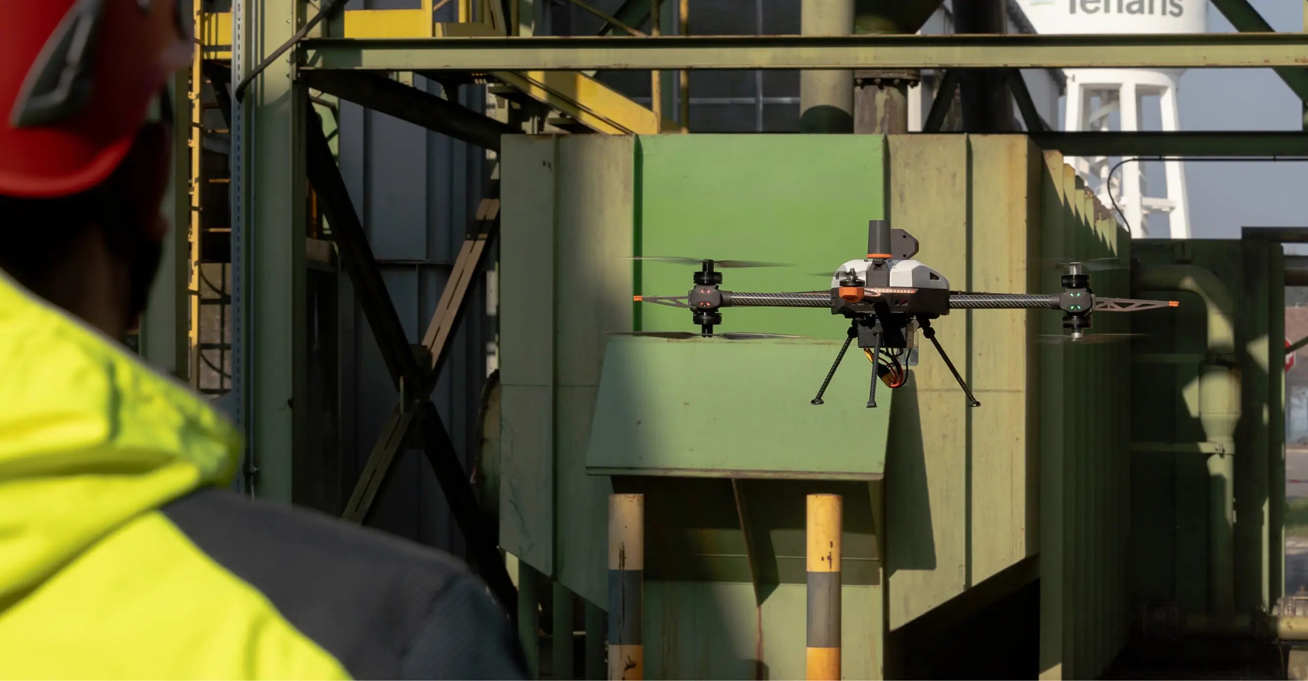 Tidalis operator monitoring an inspection drone flying near an industrial facility