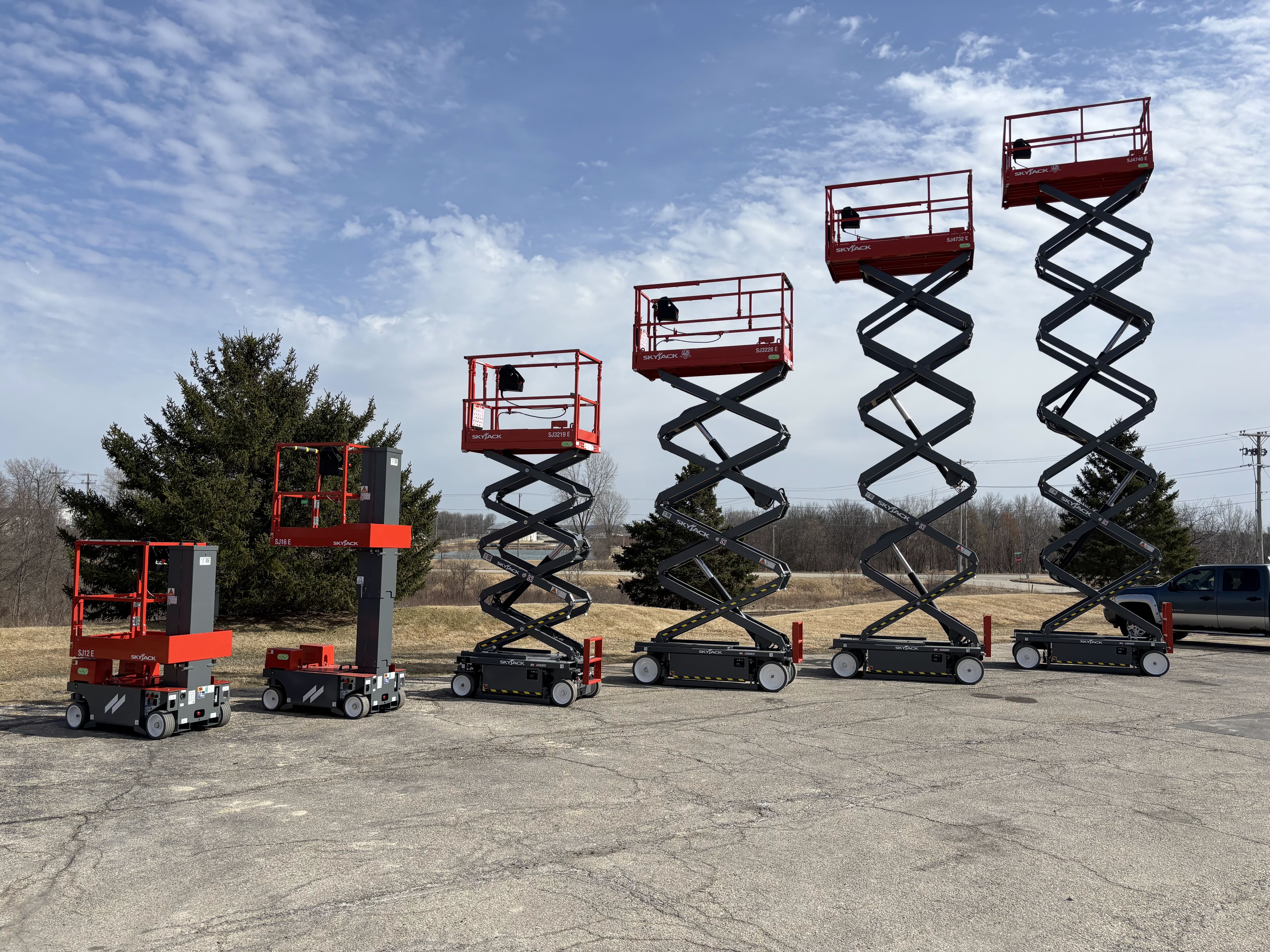 six scissor lifts lined up at different heights from shortest to tallest