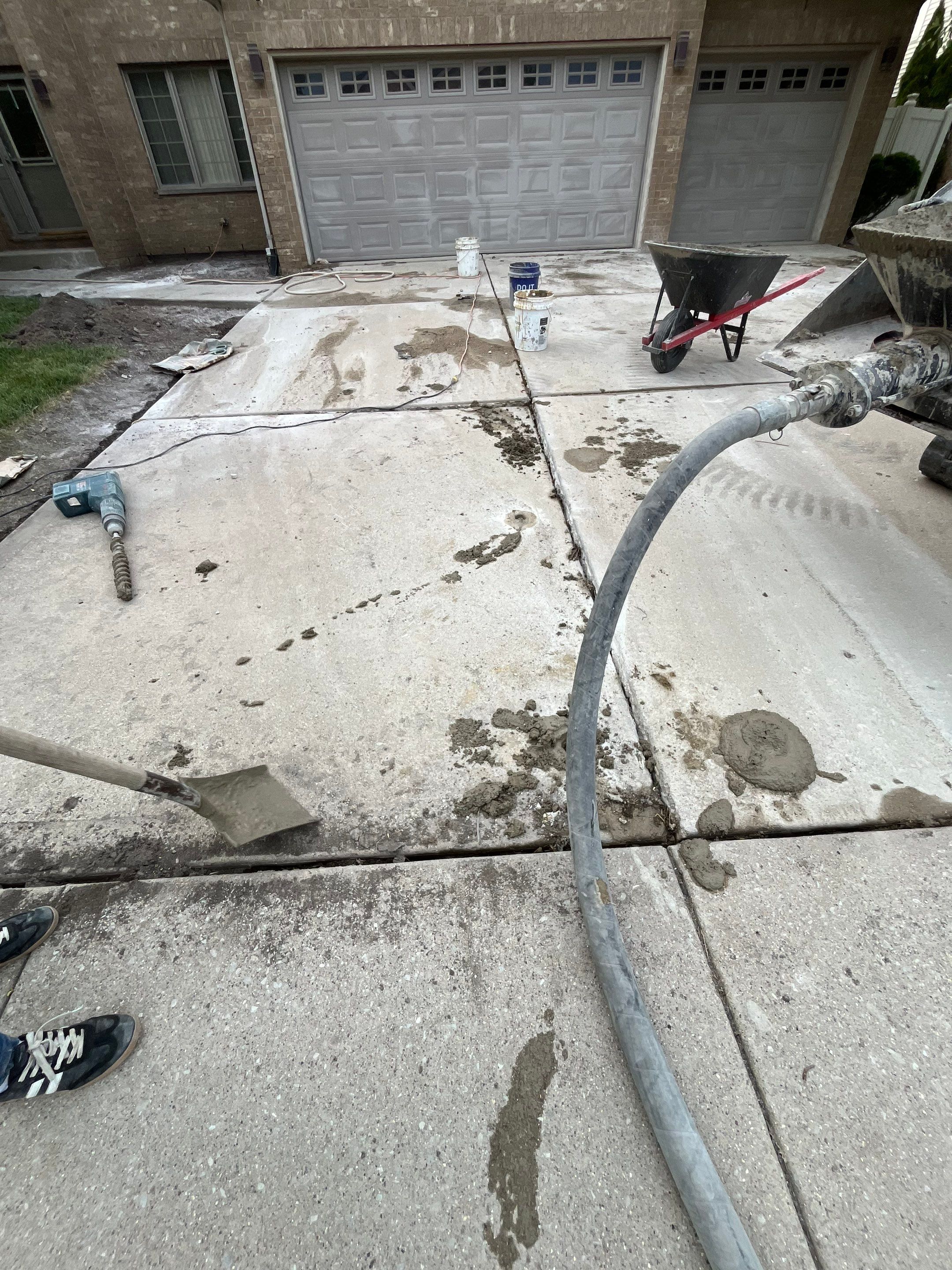Polyurethane foam injection lifting a sunken concrete driveway in Cook County