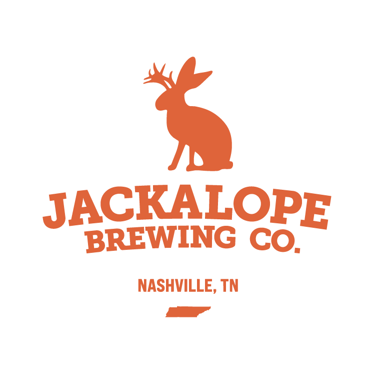 Black Abbey Brewing Co. logo featuring a stylized abbey tower with clouds and blue sky in an oval frame with gold border.