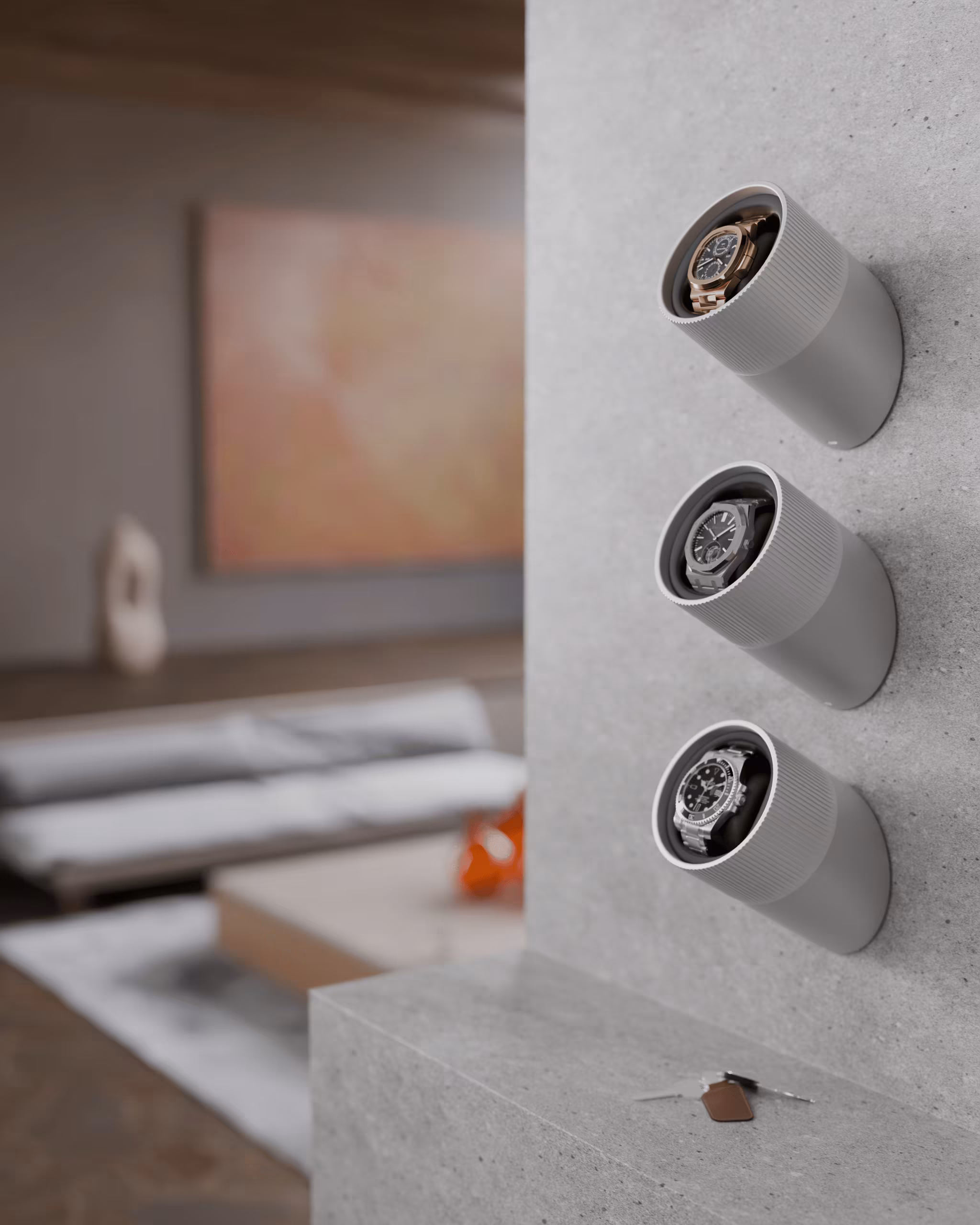 Three wristwatches stored vertically in gray cylindrical holders mounted on a concrete wall, with a blurred living room in the background.